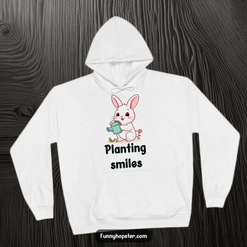 Funny hoodie with a cheerful rabbit watering a tiny flower, offering warmth and a nurturing, whimsical vibe.