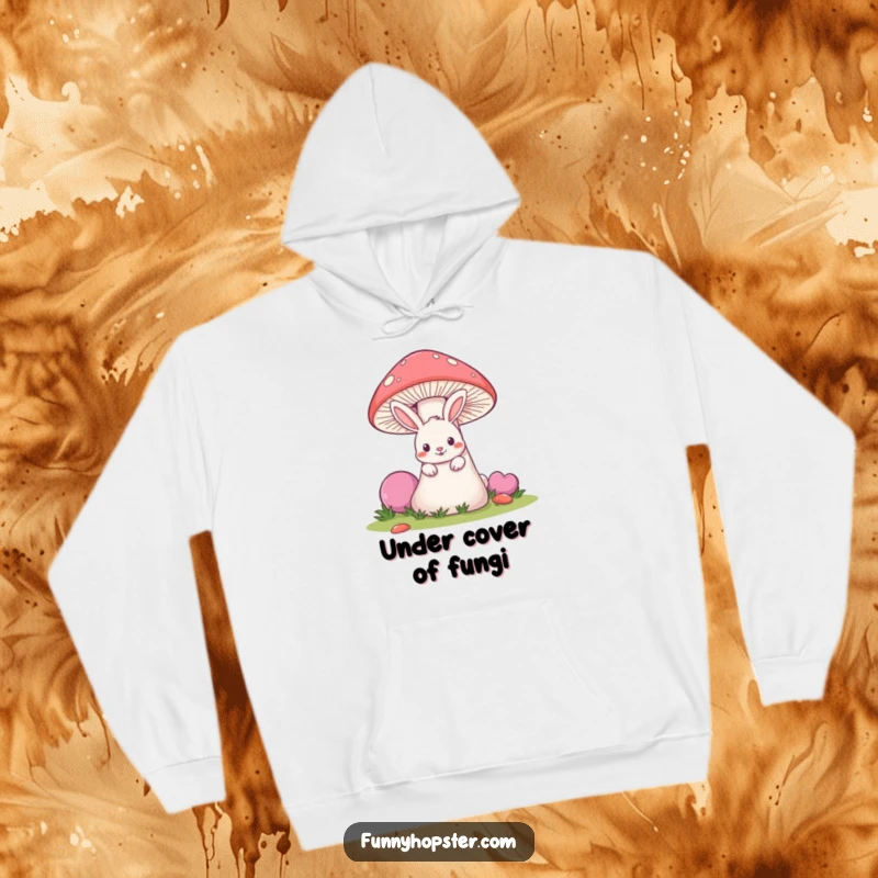 Funny hoodie depicting a mischievous rabbit peeking out from behind a giant mushroom, soft and playful.