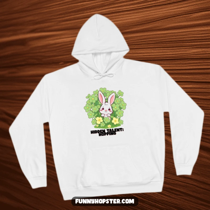 Funny rabbit peeking from a lush clover patch on a cozy hoodie, offering warmth and a touch of luck, an ideal funny gift.